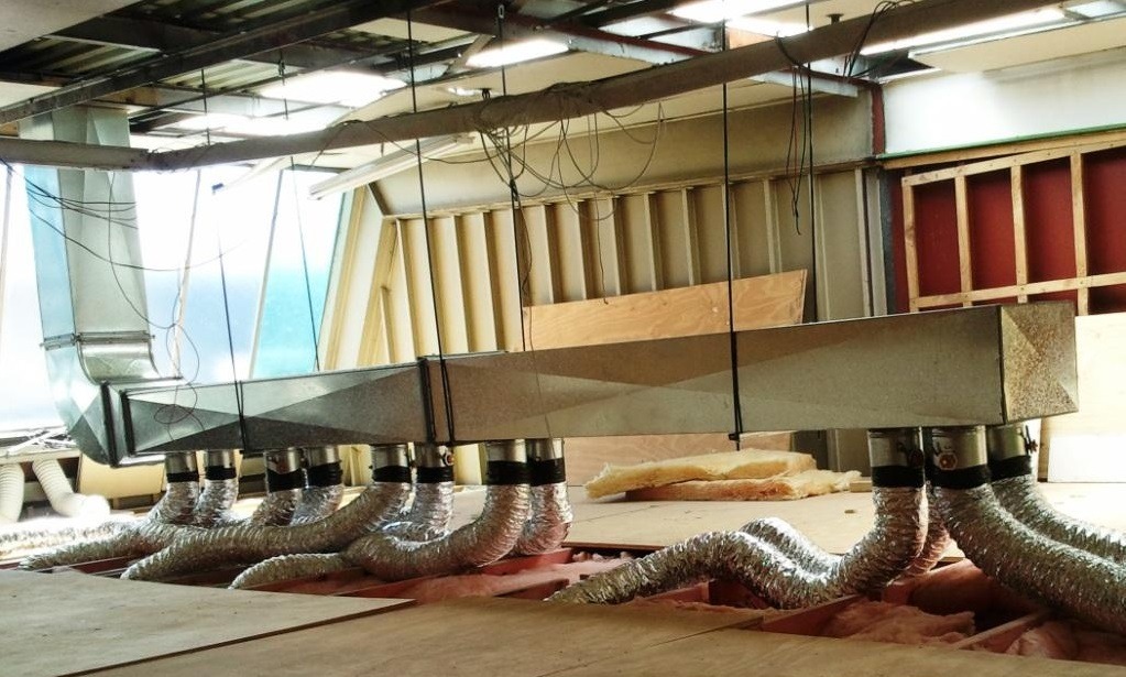 Central ducted ventilation plenum with branch spigots and flexible ducting at City Works Depot
