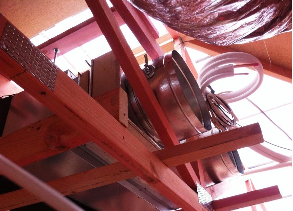 Ceiling-mounted ducted unit installed within a purpose-designed roof truss